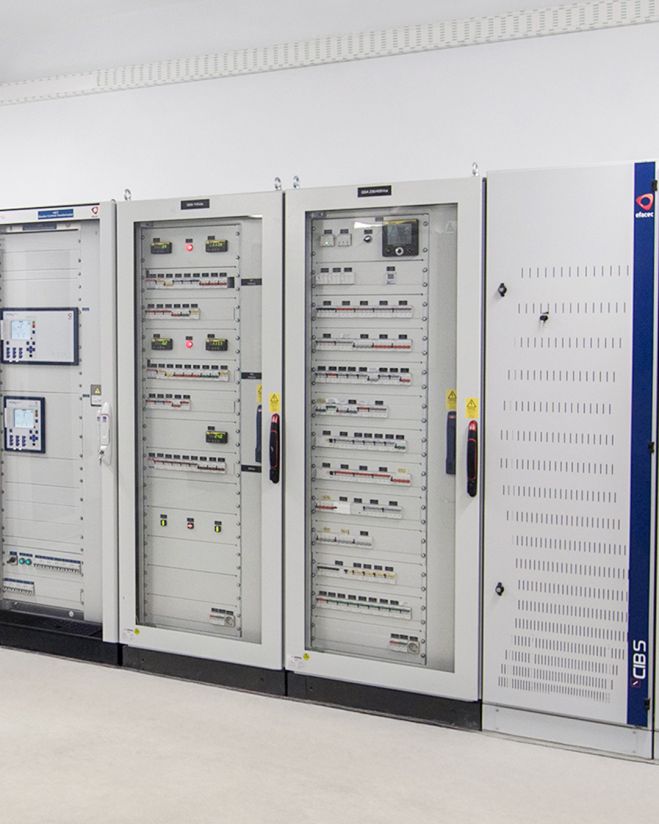 A row of industrial control panels for auxiliary power supply, with various buttons, switches and digital displays.